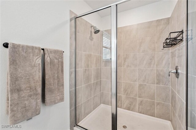 bathroom featuring a shower with shower door