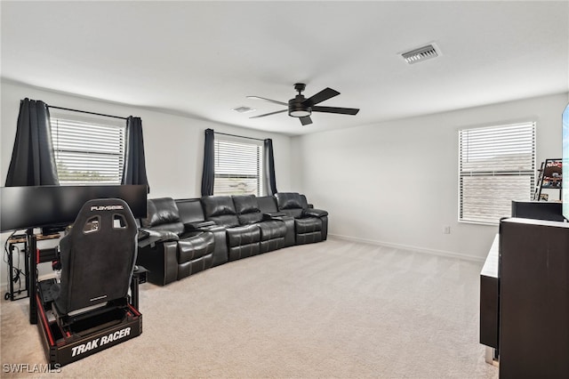 carpeted living room featuring a healthy amount of sunlight and ceiling fan