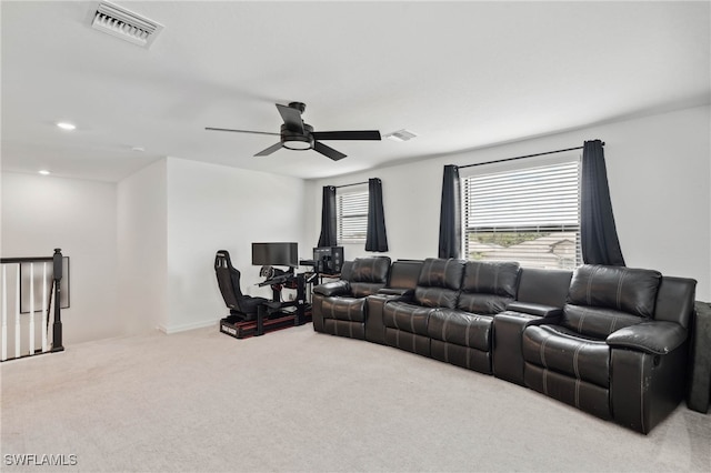 carpeted living room with ceiling fan