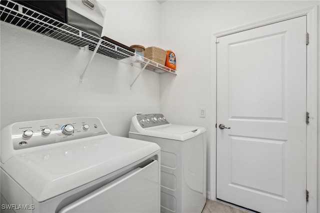 washroom with independent washer and dryer