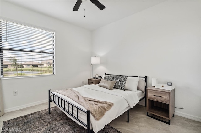 tiled bedroom featuring ceiling fan