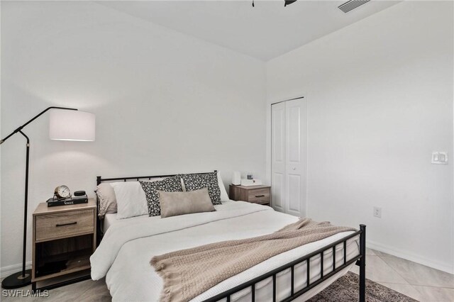 tiled bedroom with a closet