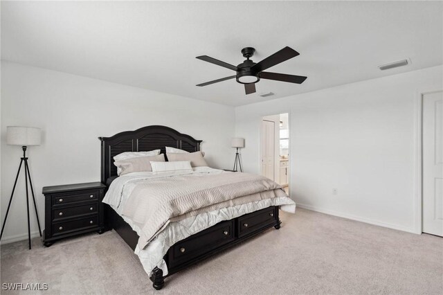 carpeted bedroom featuring ensuite bathroom and ceiling fan