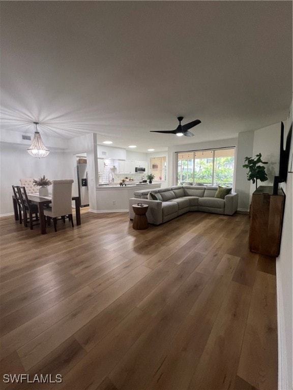 living room featuring dark hardwood / wood-style flooring and ceiling fan