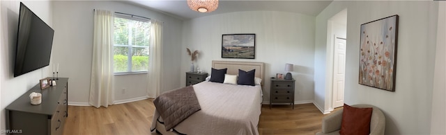 bedroom with light wood-type flooring and multiple windows