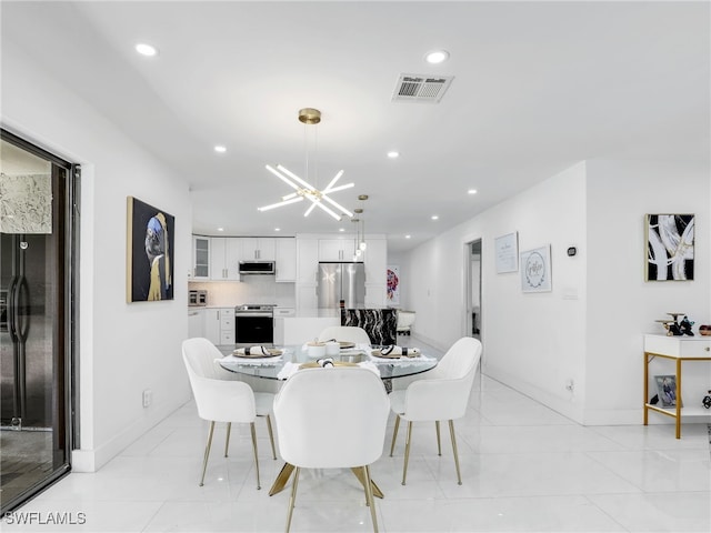 dining area with light tile patterned floors and a notable chandelier