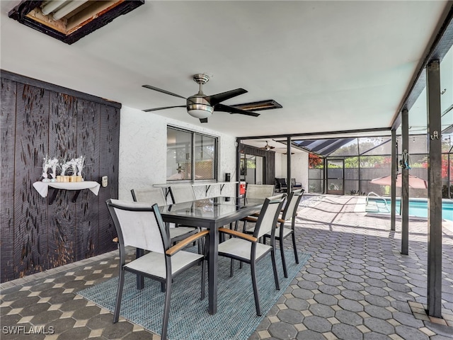 view of patio featuring ceiling fan and a lanai