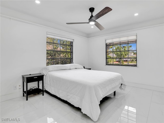 bedroom featuring ceiling fan, ornamental molding, and multiple windows