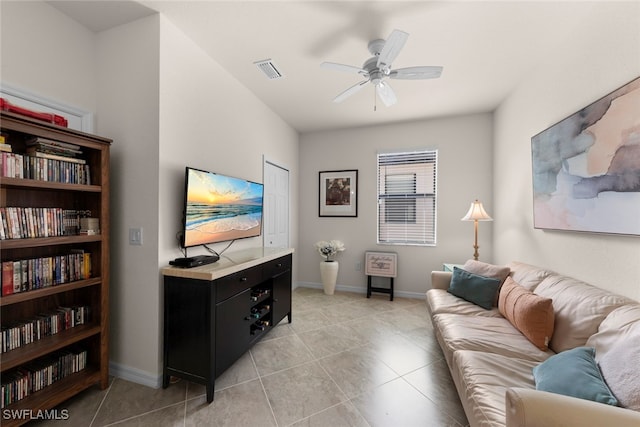 living room featuring light tile patterned floors, baseboards, visible vents, and ceiling fan