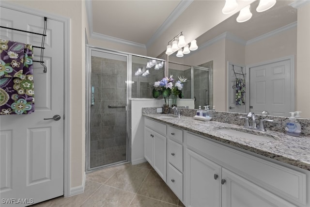 bathroom with a shower stall, crown molding, and a sink