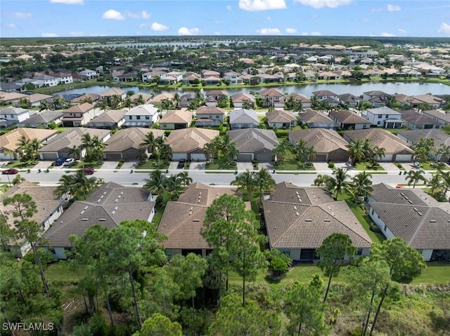 drone / aerial view featuring a residential view and a water view