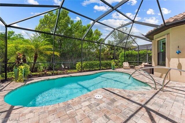 outdoor pool featuring a lanai, a patio, and an outdoor living space