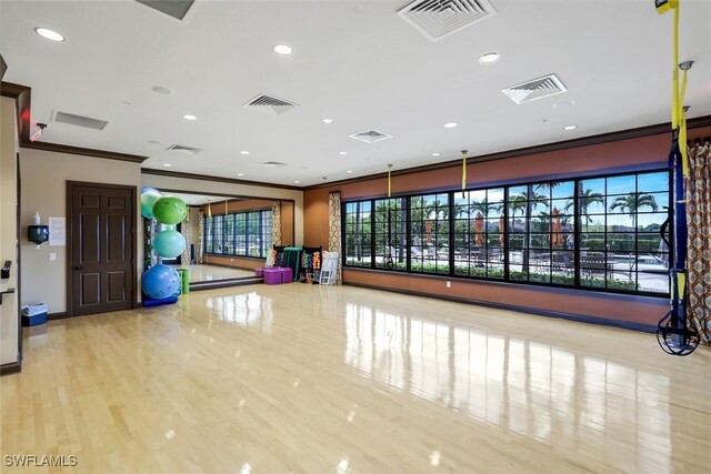 workout area featuring recessed lighting, visible vents, and ornamental molding