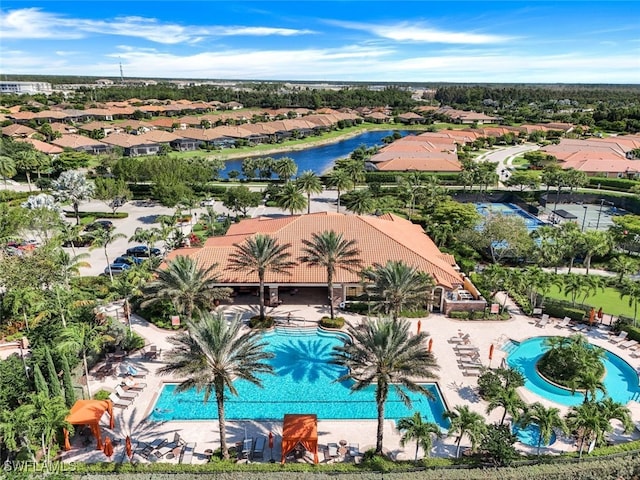 birds eye view of property with a water view and a residential view