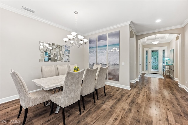 dining space with baseboards, arched walkways, ornamental molding, dark wood-type flooring, and an inviting chandelier