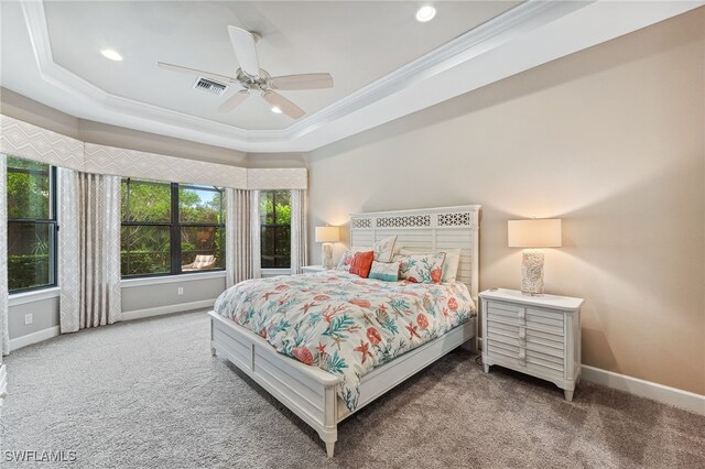 bedroom featuring ornamental molding, carpet floors, a tray ceiling, and baseboards