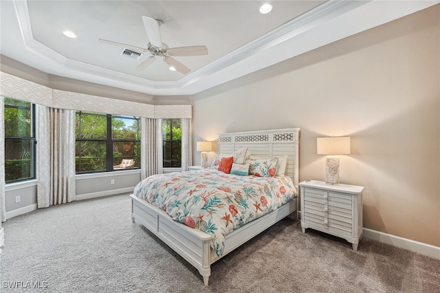 bedroom featuring baseboards, a raised ceiling, carpet flooring, and crown molding