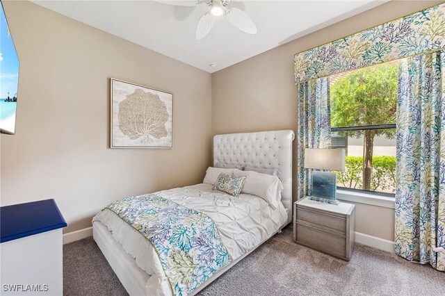 carpeted bedroom featuring ceiling fan and baseboards