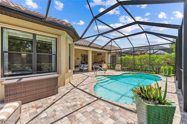 pool featuring a lanai, outdoor lounge area, and a patio area