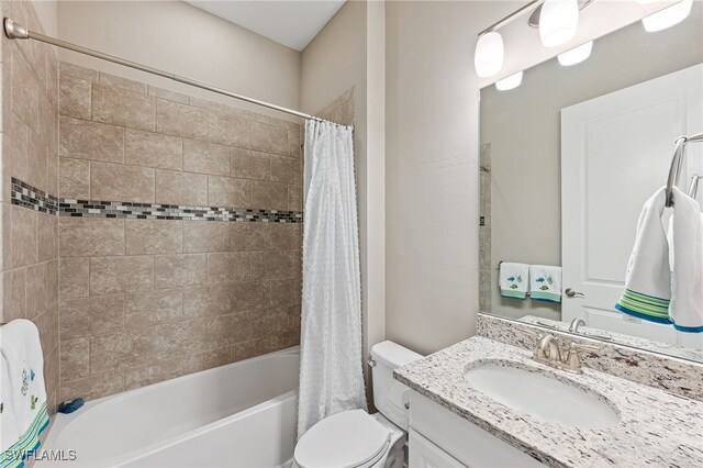 bathroom with toilet, shower / bath combination with curtain, and vanity