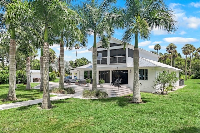 rear view of house featuring a yard and a patio area