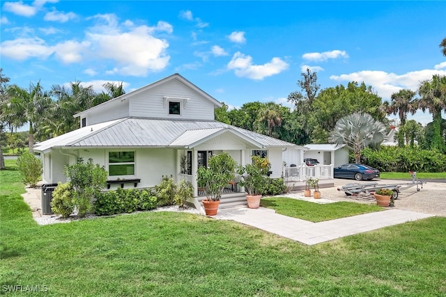 exterior space with a porch and a front lawn