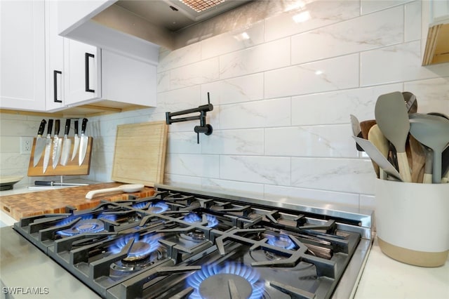 room details with white cabinetry, backsplash, and wood counters