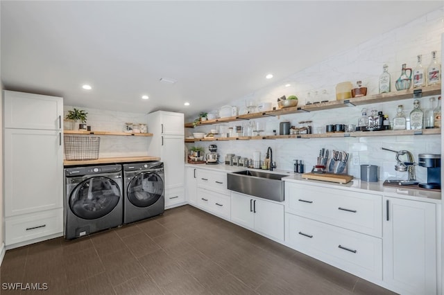 washroom featuring washer and dryer and sink