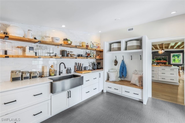 mudroom with dark hardwood / wood-style flooring and sink