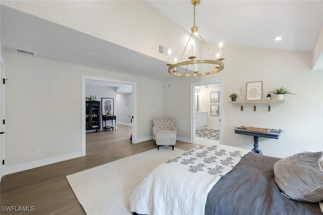 bedroom with dark hardwood / wood-style flooring, connected bathroom, a chandelier, and vaulted ceiling