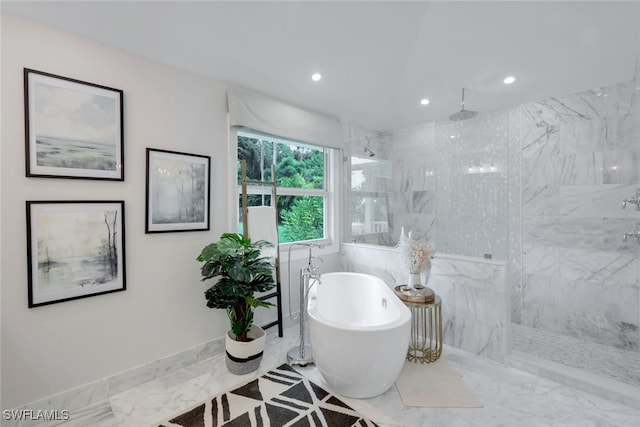 bathroom featuring shower with separate bathtub