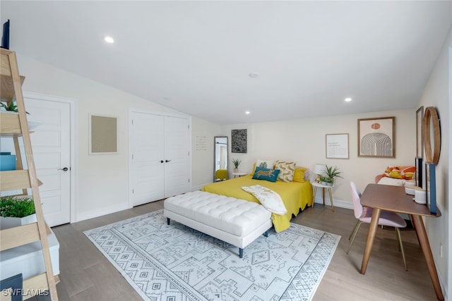 bedroom featuring a closet, lofted ceiling, and hardwood / wood-style floors