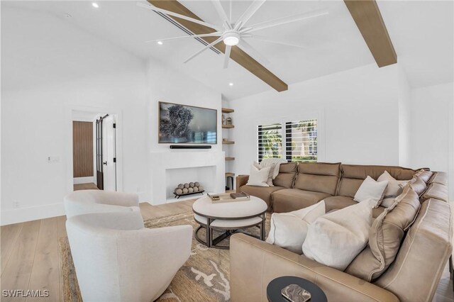 living room featuring high vaulted ceiling, ceiling fan, beamed ceiling, and light hardwood / wood-style flooring