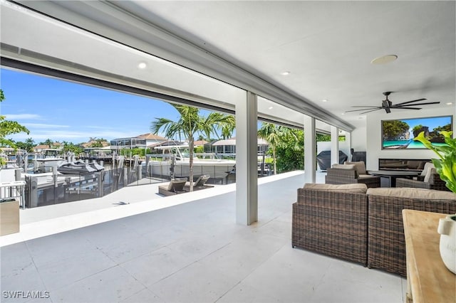 view of patio / terrace with a dock and ceiling fan