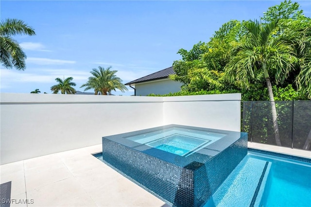 view of pool featuring an in ground hot tub, fence, and a fenced in pool