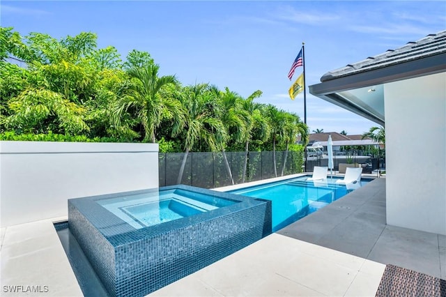 view of swimming pool featuring a fenced in pool, fence, a patio, and an in ground hot tub