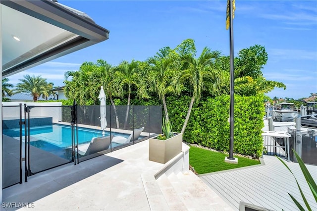 view of swimming pool featuring a patio area, fence, and a fenced in pool