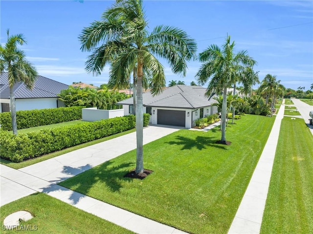 single story home with an attached garage, concrete driveway, and a front yard