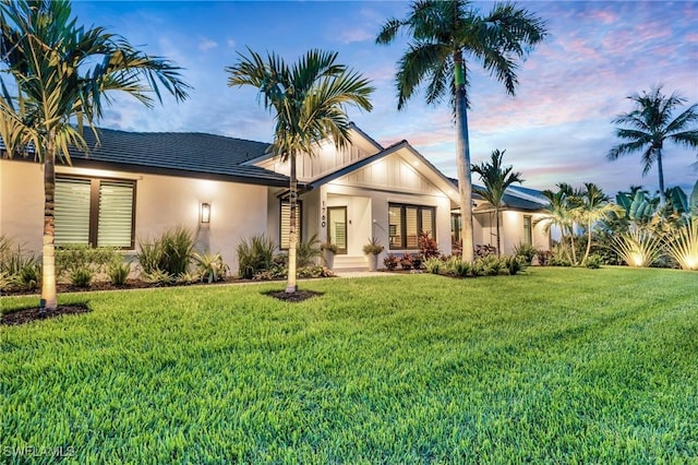 view of front of house with a front lawn and stucco siding