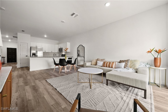 living room with light hardwood / wood-style floors