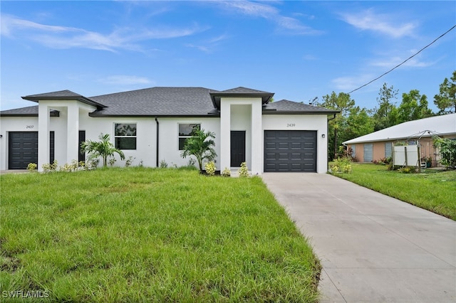 view of front facade featuring a garage and a front yard