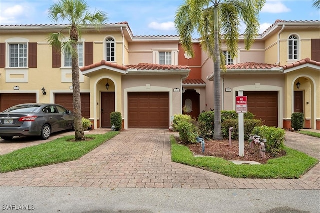 mediterranean / spanish-style home with a garage