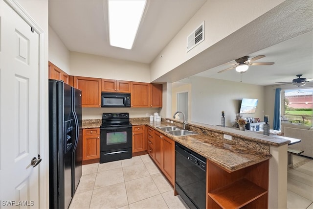 kitchen with black appliances, light tile patterned floors, kitchen peninsula, sink, and ceiling fan