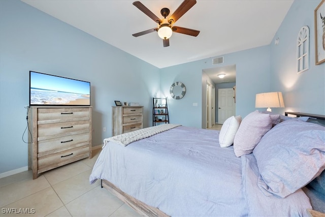 tiled bedroom featuring ceiling fan