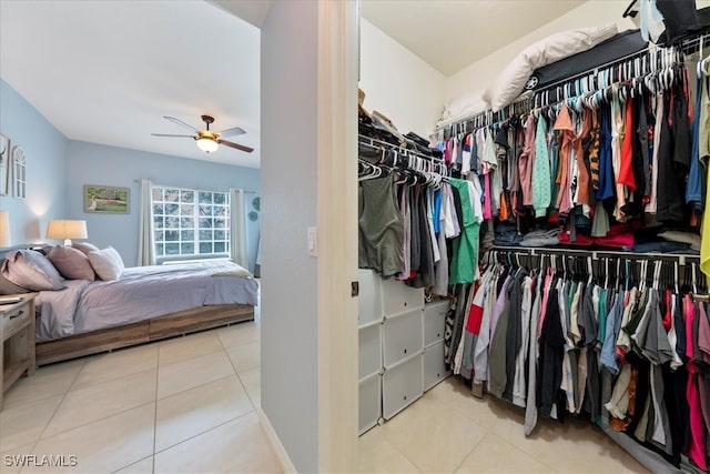 spacious closet with ceiling fan and light tile patterned flooring