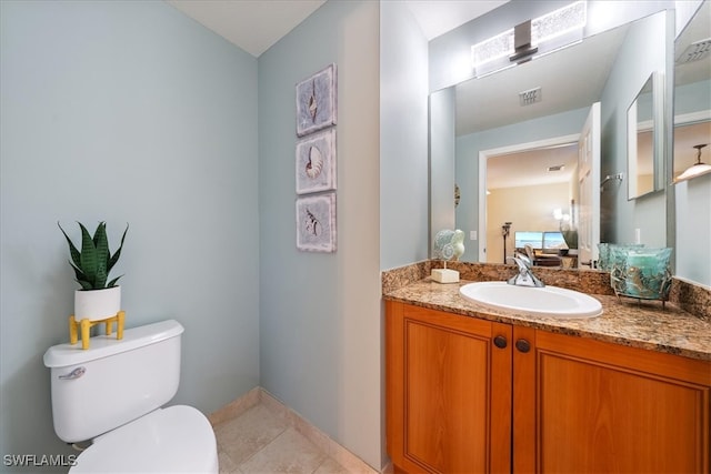 bathroom featuring vanity, toilet, and tile patterned flooring