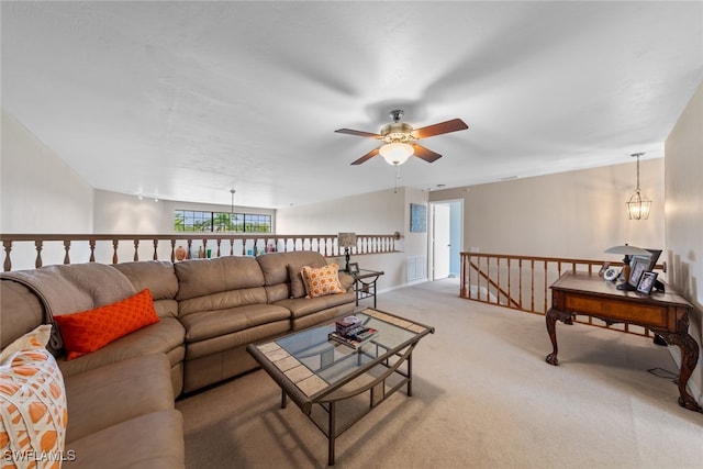 living room featuring ceiling fan with notable chandelier and light colored carpet