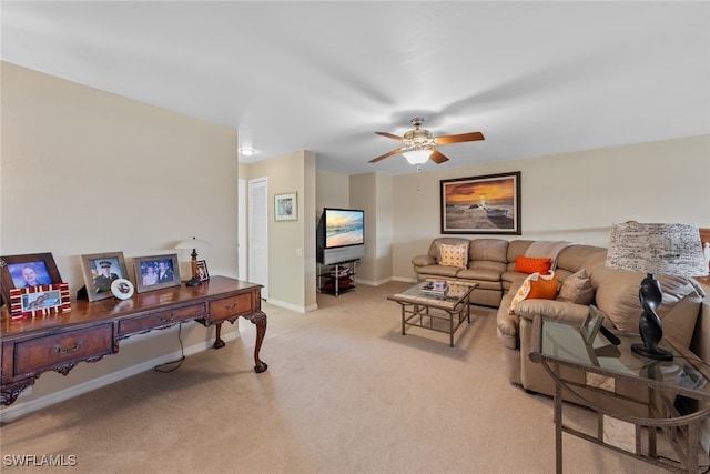 carpeted living room with ceiling fan