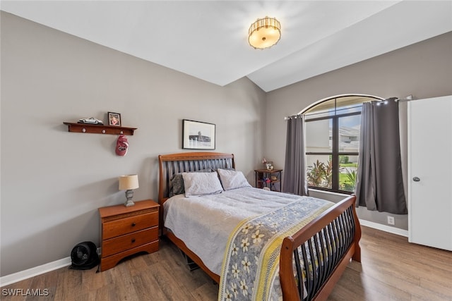 bedroom featuring vaulted ceiling and hardwood / wood-style floors