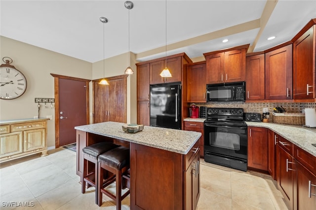 kitchen featuring a kitchen island, light stone countertops, black appliances, pendant lighting, and decorative backsplash